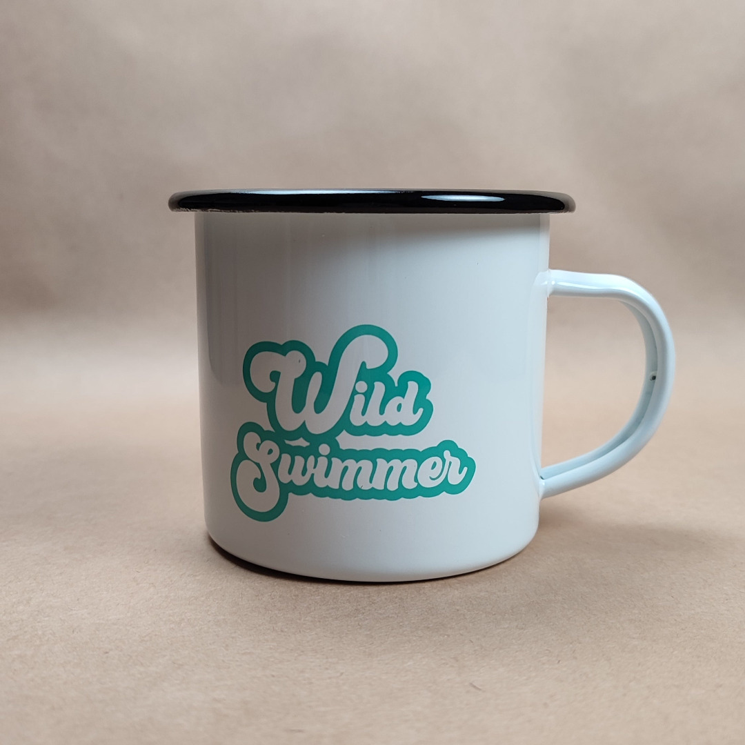 This is an enamel mug with the words "Wild Swimmer" printed on both sides. Designed and printed in Ireland.